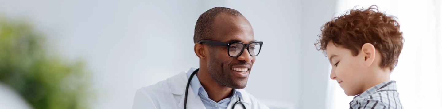 A smiling doctor treating a young boy