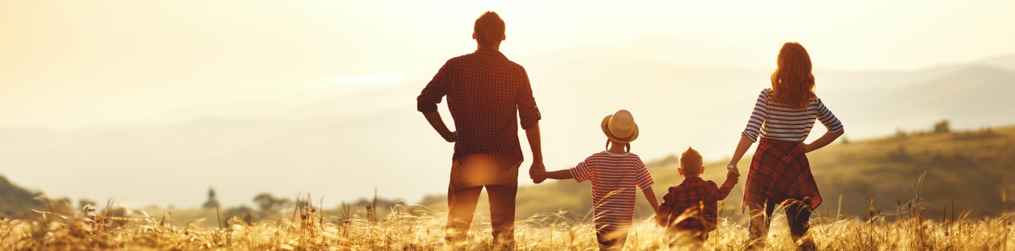 Family standing in a meadow